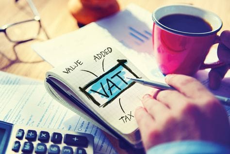 VAT calculation on a calculator, heading an article on 5% VAT in the UAE