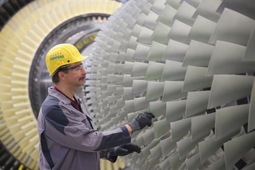 Engineer with a Siemens turbine, heading an article on the Iraq energy agreement