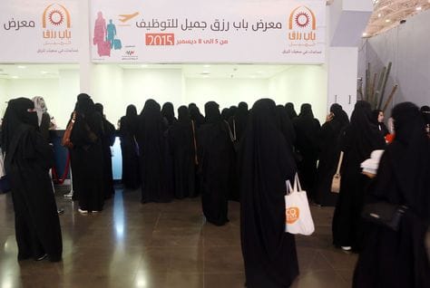 Job seekers at a careers event, heading an article on Saudi Arabia's labour scheme
