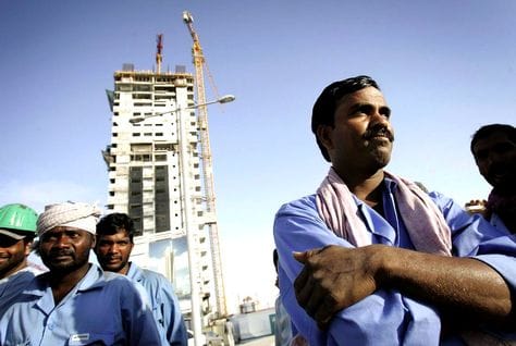 Workers at a training session in Dubai, heading an article on labour rights training