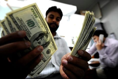 Money transfer counter, heading an article on Pakistani expat remittances