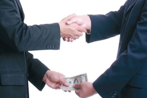 Two people shaking hands, heading an article on Saudi private sector salaries