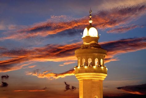 Crescent moon over a mosque, heading an article on the start of Eid al-Fitr
