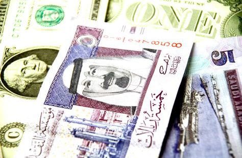 Saudi riyal banknotes, heading an article on expat remittances and earnings
