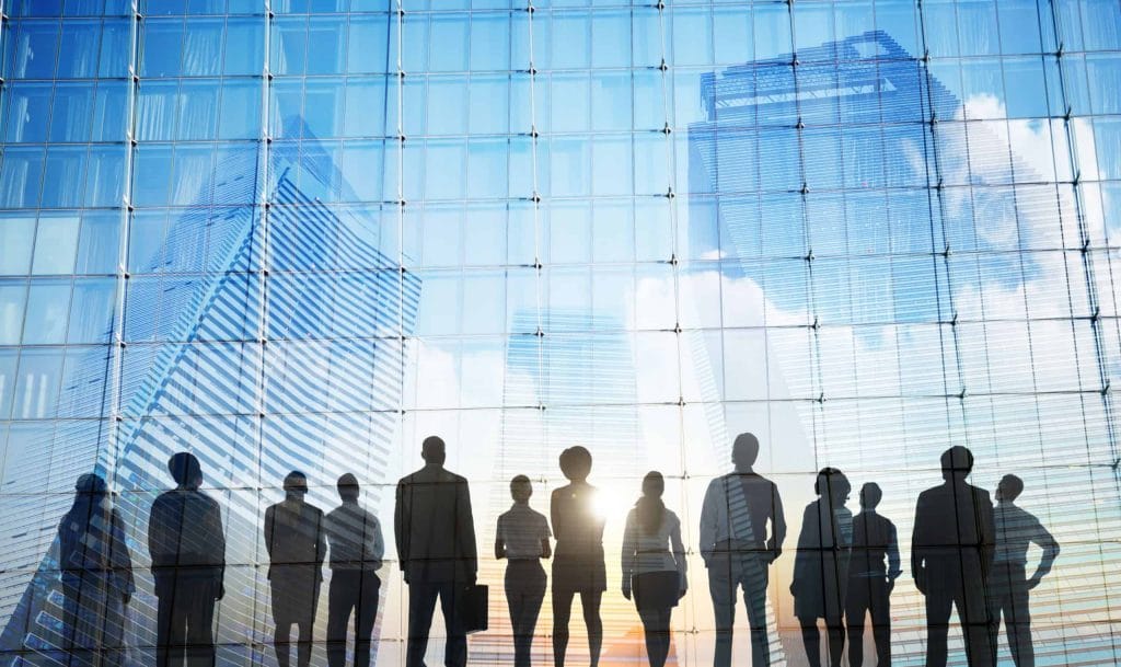 Business people in a meeting, heading an article on regional economies beyond Covid-19