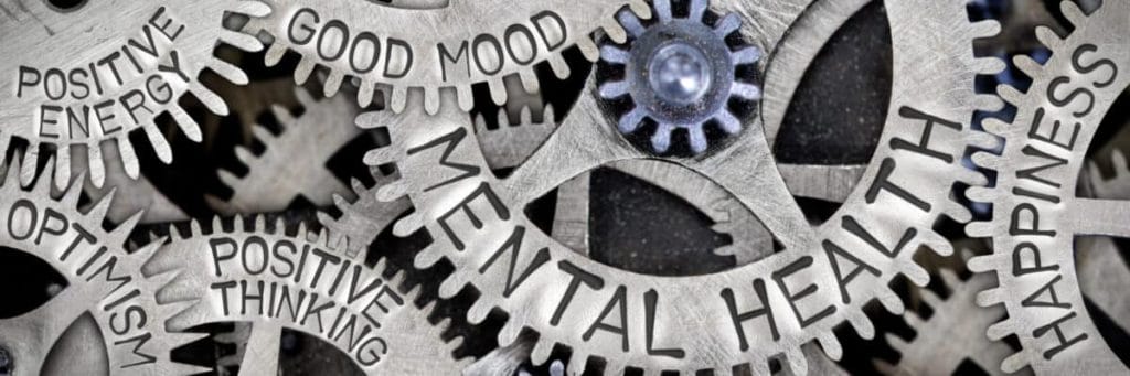 Cogwheel mechanism spelling out mental health, heading an article on managing mental health