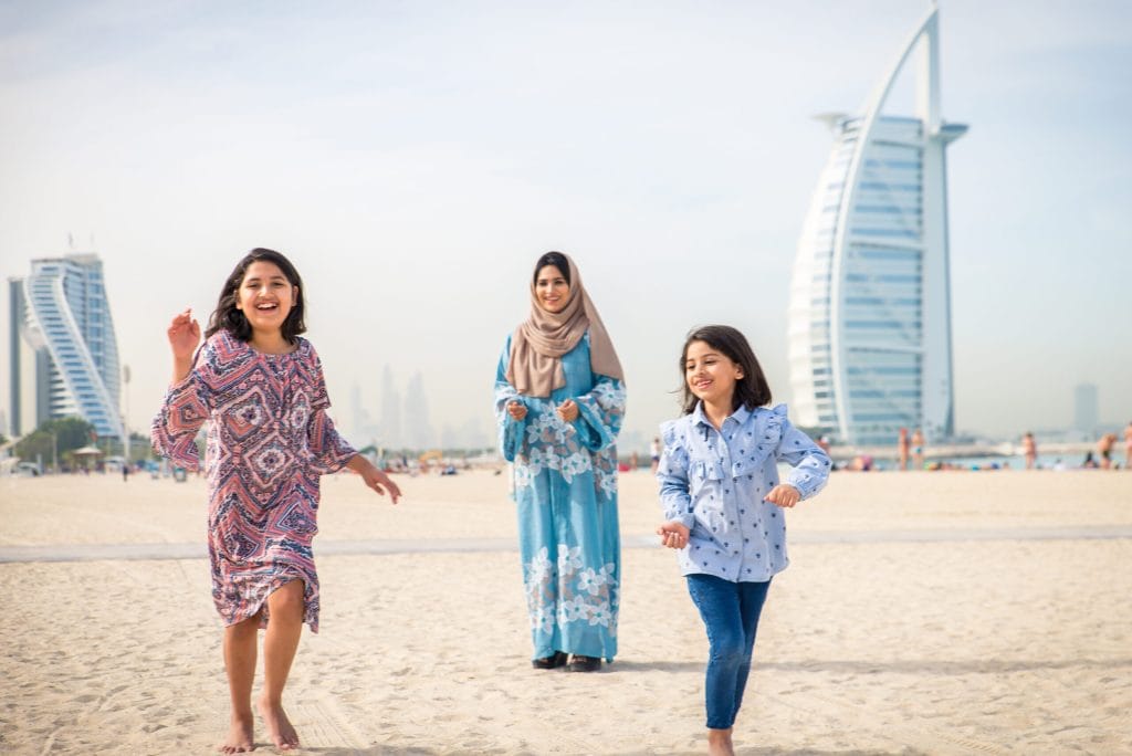 A family together in Dubai, illustrating why British families are moving to the UAE